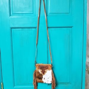 Small, brown and white crossbody purse.